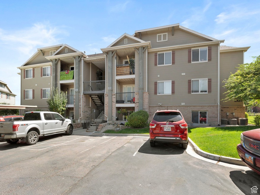 View of property with uncovered parking