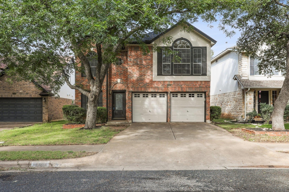 Traditional-style home with concrete driveway and