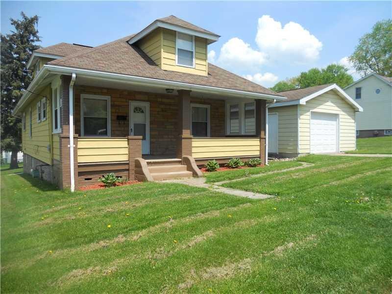 Exterior Front. Sitting on a corner double-lot, th
