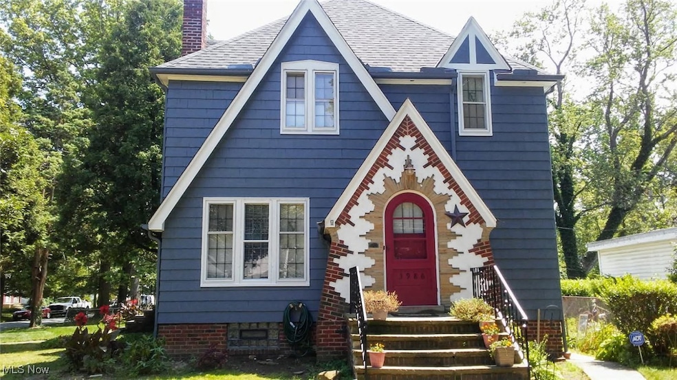 View of front of house with a chimney and a shingled roof