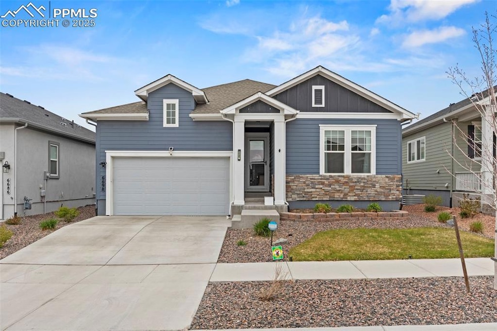 View of front of home featuring stone siding, boar