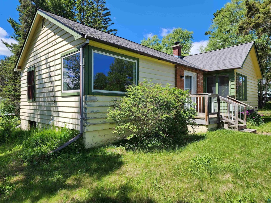 Single story home featuring a front lawn and an at