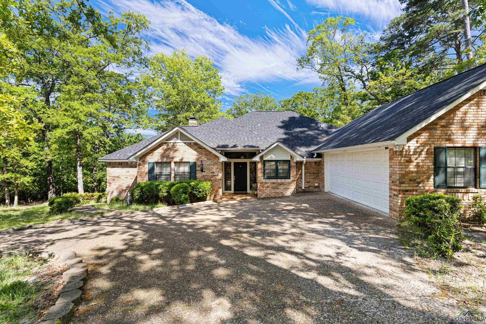 Ranch-style house featuring brick siding, an attac