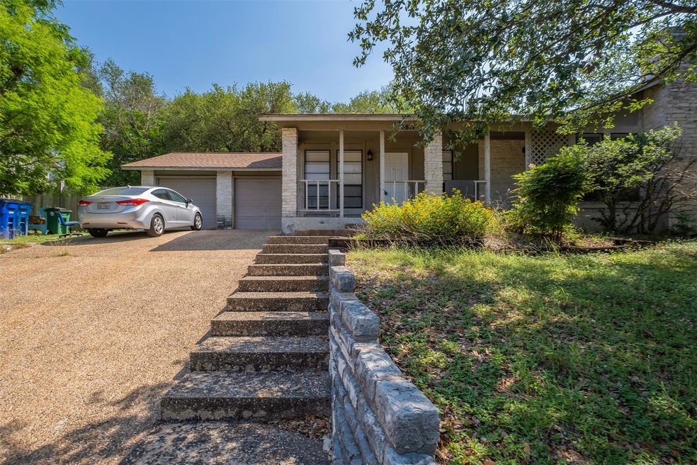 View of front of property with a garage, driveway