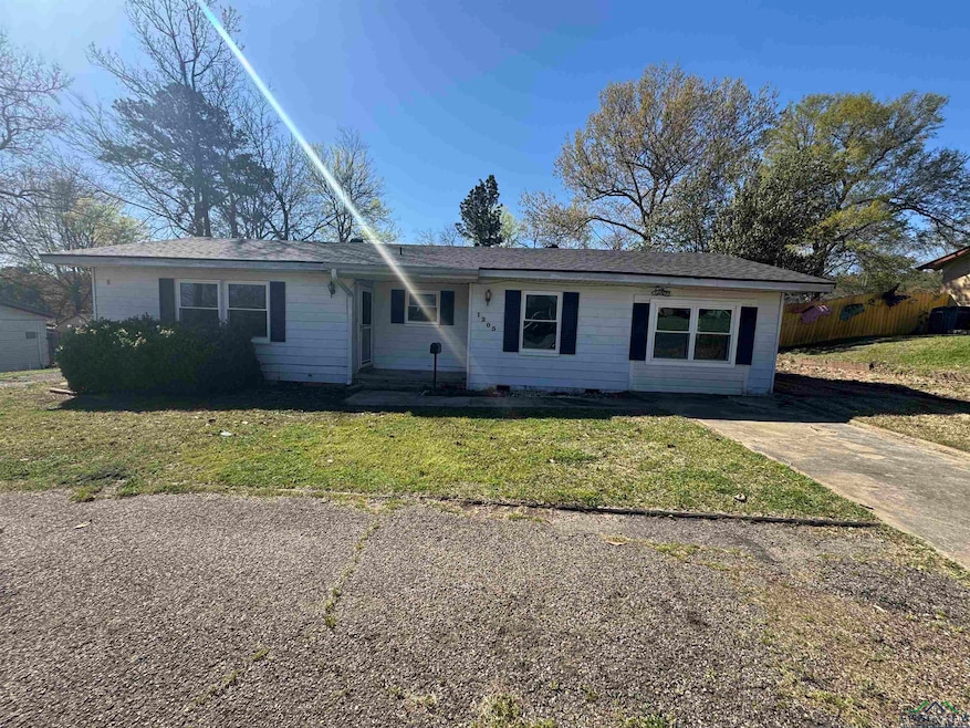 Single story home with a front yard, concrete driv