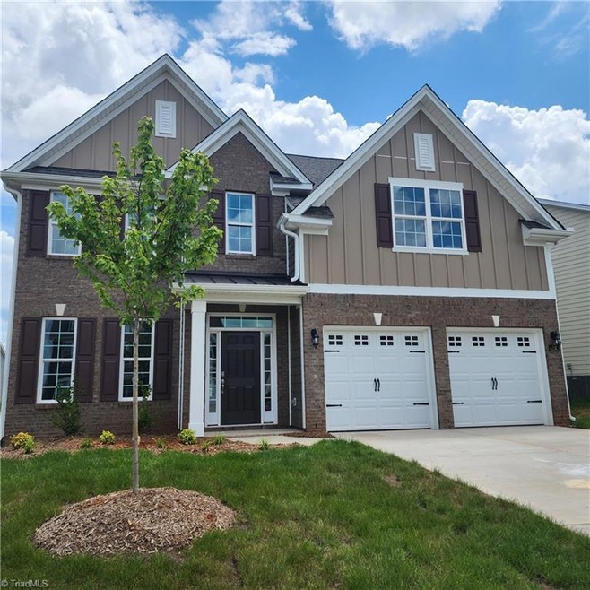 HardiPlank exterior with stone accents. Fully sodded yard
