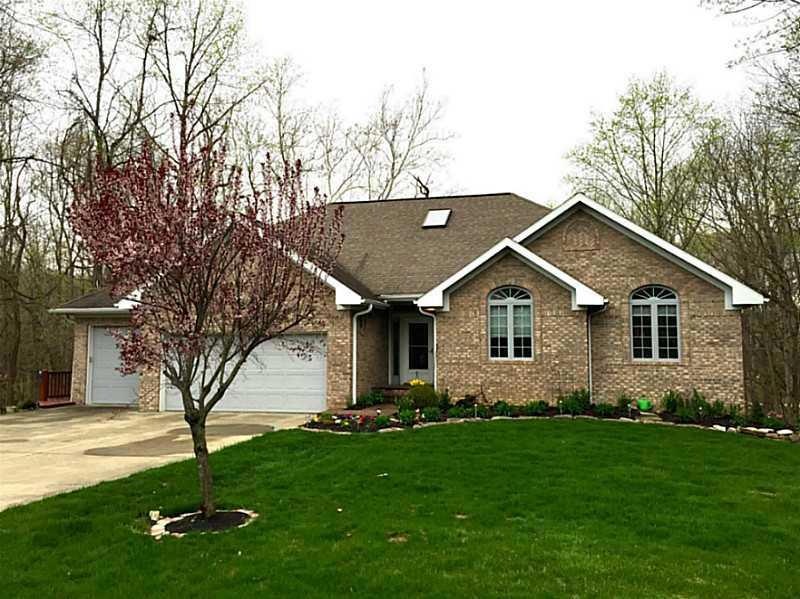Exterior Front. Beautiful setting and a three car garage.