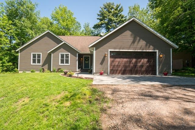 Front view of the home features a new stamped conc
