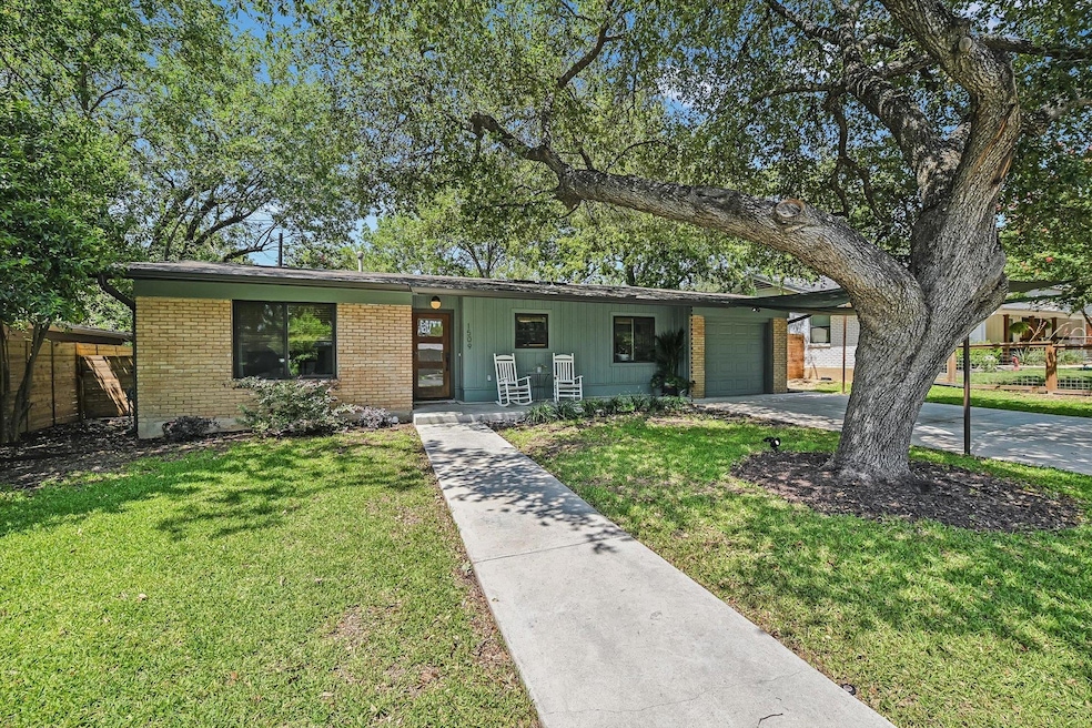 View of front of home with driveway, an attached 