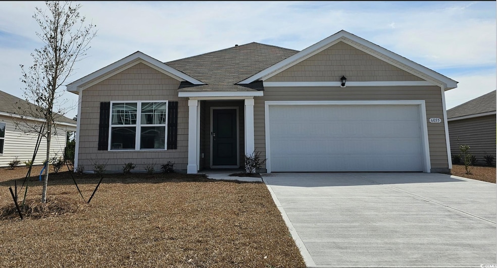 View of front of home featuring driveway, a shingl