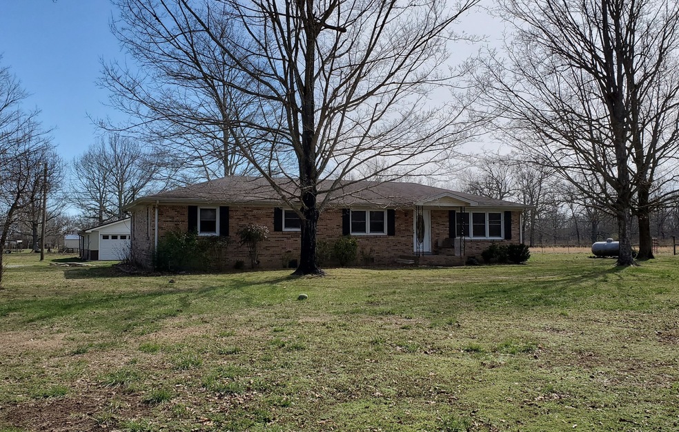 This is a lovely move-in  ready all brick home that has been very well maintained over the years. 3 Bedrooms with the potential for a 4th Bedroom.   Oversize Garage / Workshop & Lawn Garage all on 5 acres.