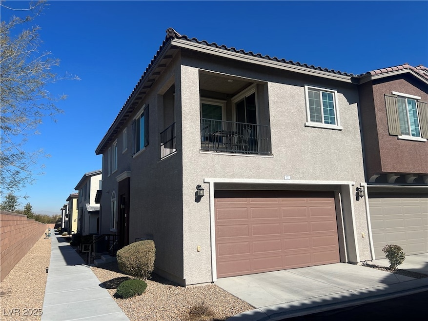 View of front of property with stucco siding, a ga