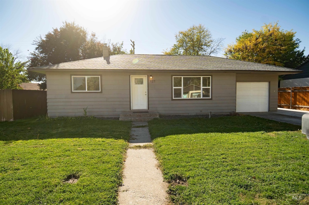 Single story home with roof with shingles, driveway, and an attached garage