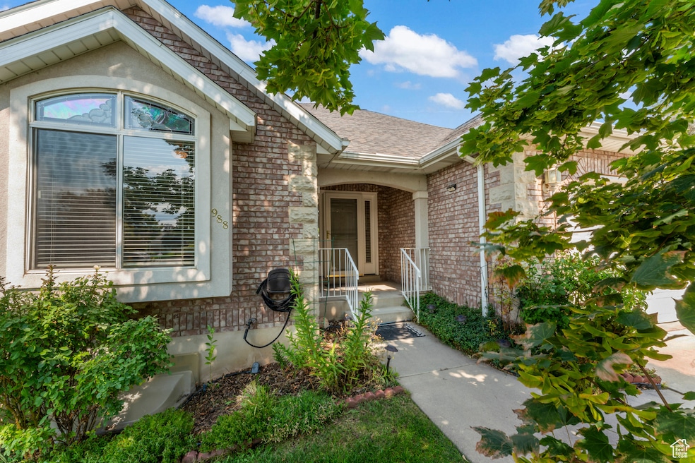 Cozy porch front entry with brick siding and roof with shingles