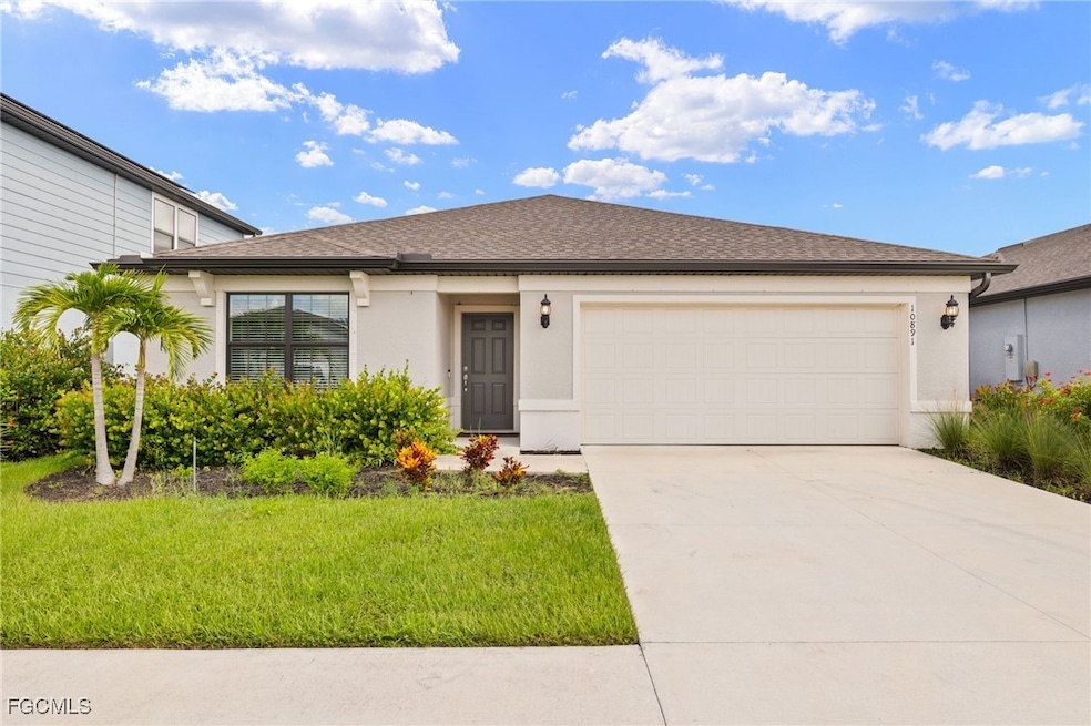 Single story home featuring stucco siding, driveway, an attached garage, and a front lawn