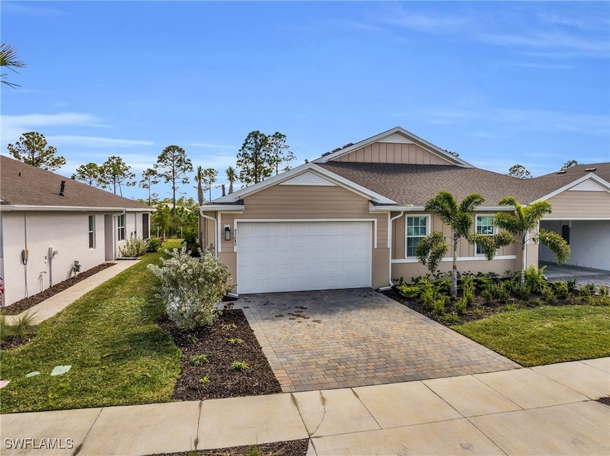 Single story home featuring a garage and a front y