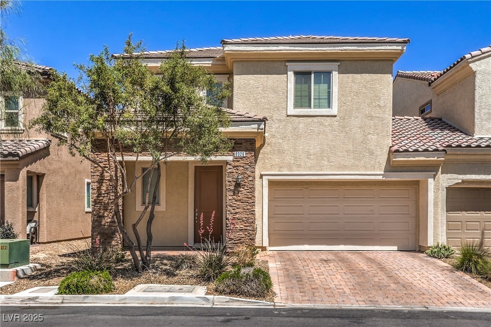 View of front of house featuring a garage, a tile