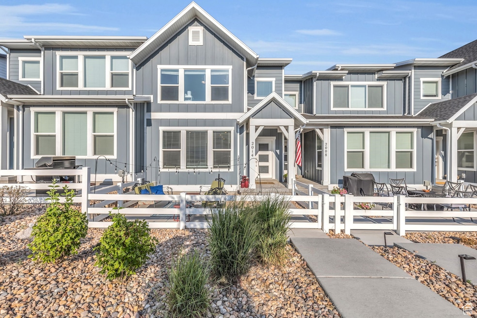 View of front facade featuring a fenced front yard, board and batten siding, and a gate