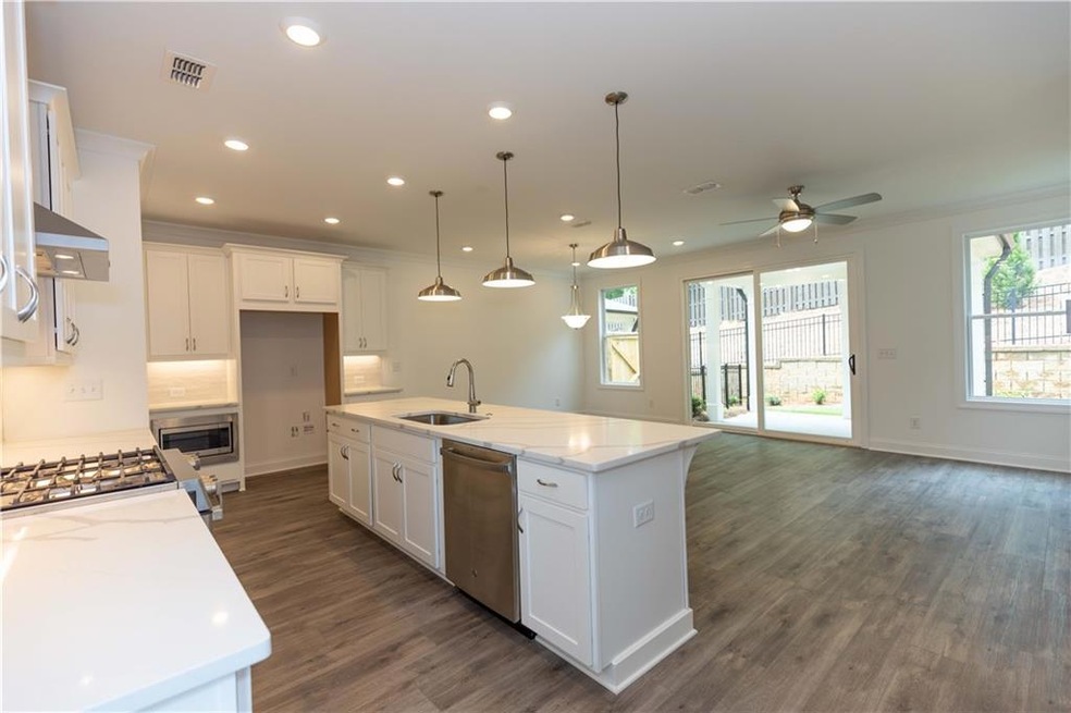 Gourmet kitchen has quartz counters and stainless 