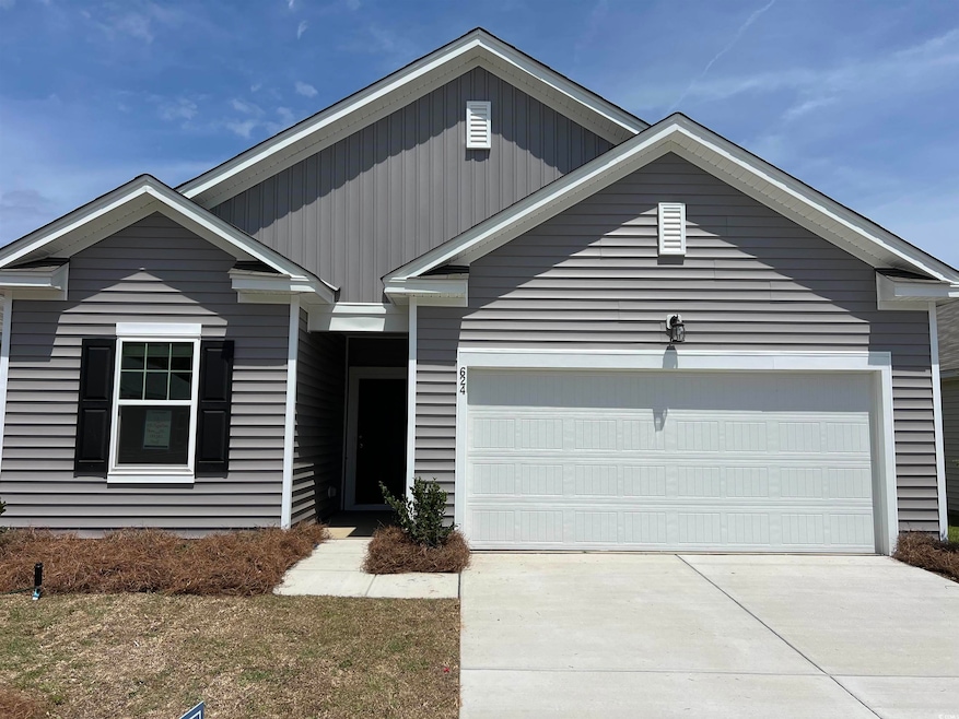 View of front of home with driveway and an attache