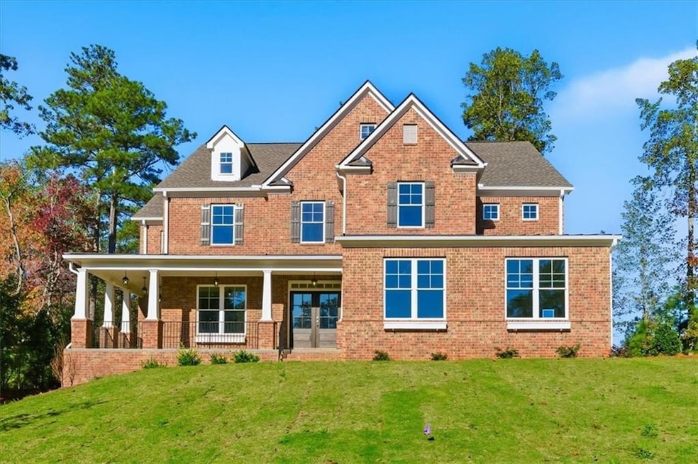 Craftsman-style house featuring brick siding, covered porch, and a front lawn