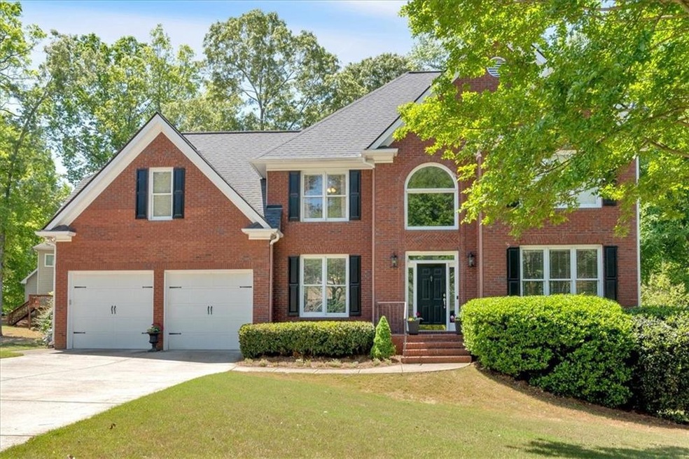 Colonial inspired home featuring brick siding, an 