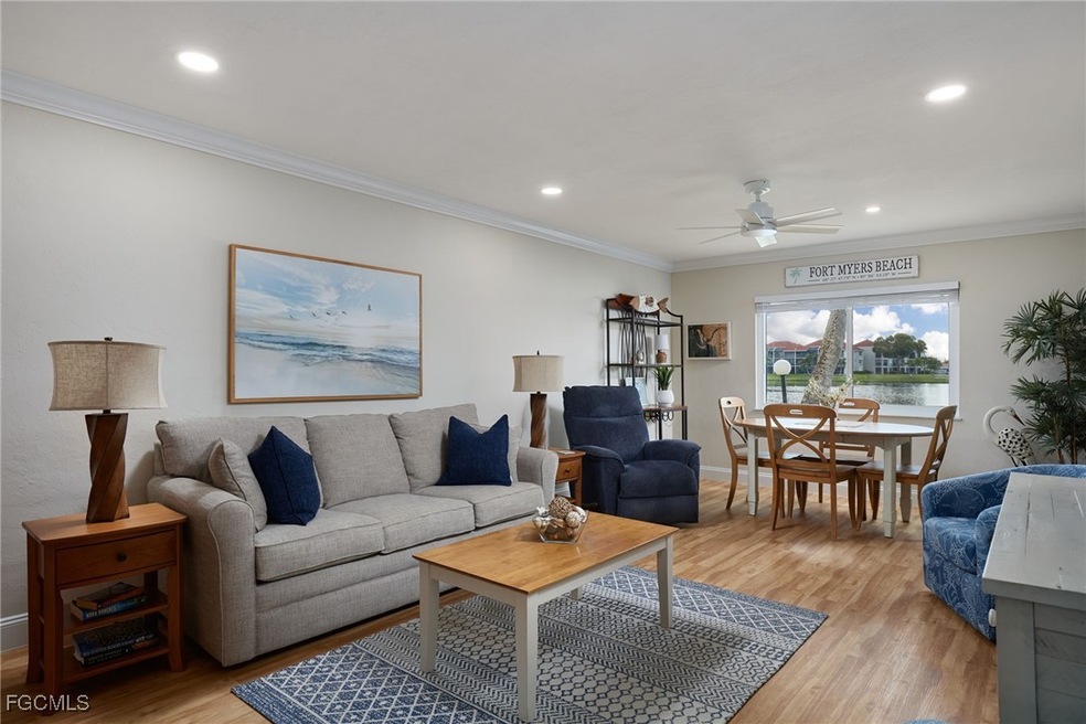 Living area with light wood-style flooring, ornamental molding, ceiling fan, recessed lighting, and a water view