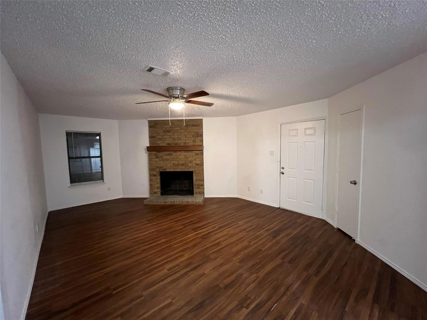 Unfurnished living room with a textured ceiling, c
