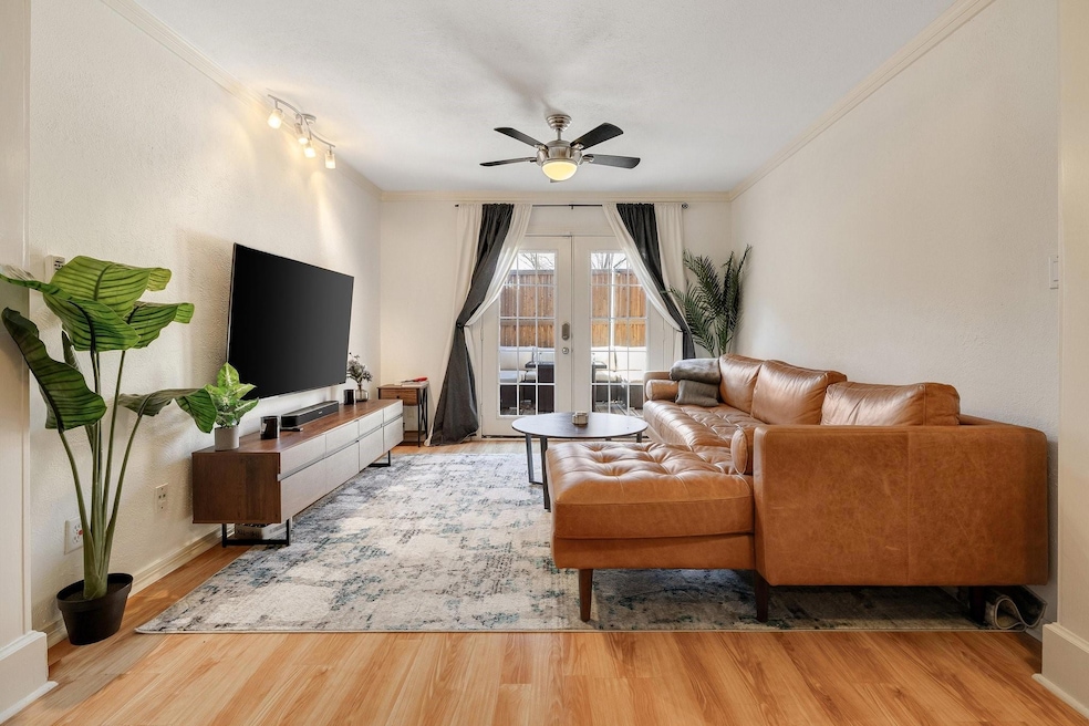 Living room featuring crown molding, wood finished