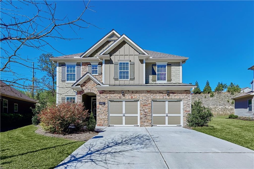 View of front of house with a garage and a front y