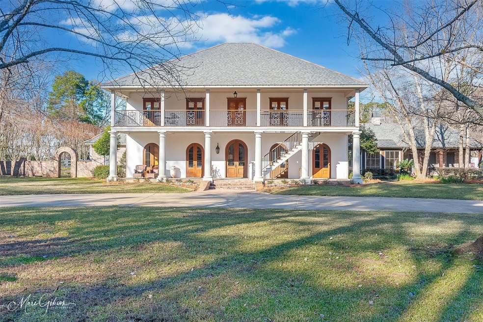 View of front of home featuring a front yard, a po
