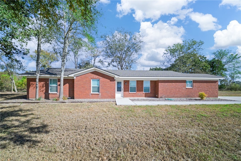 Ranch-style home with brick siding and a front yard