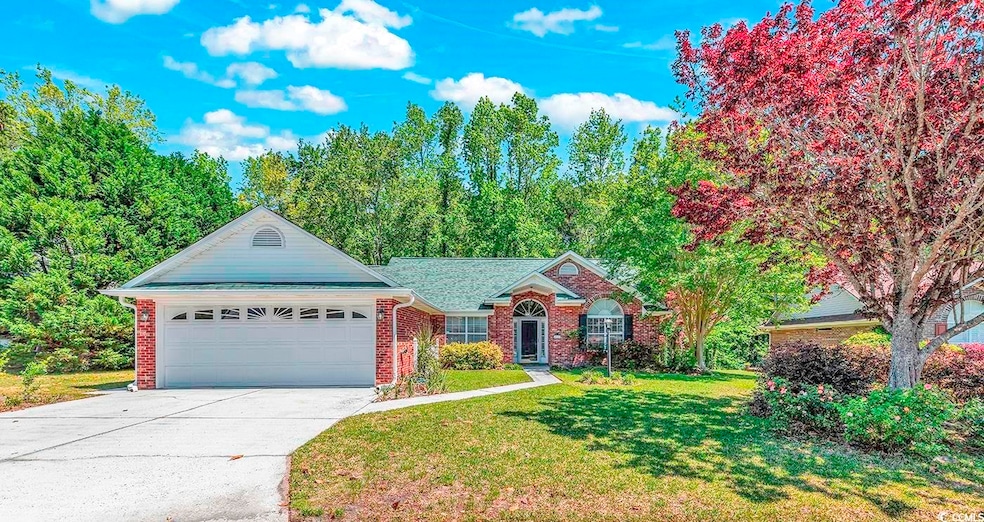Single story home featuring a garage and a front l