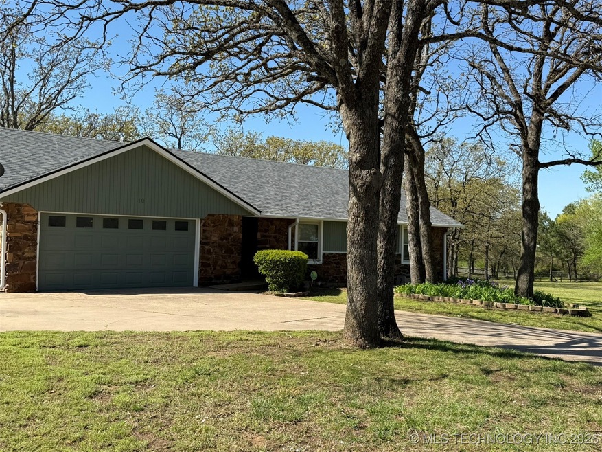 View of front of property with stone siding, roof
