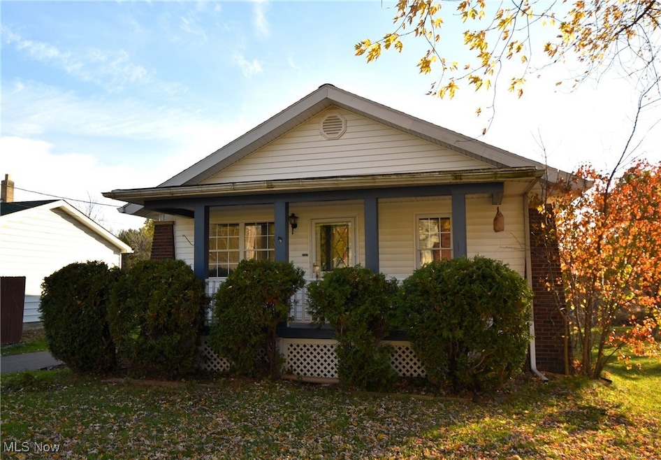 Bungalow-style home featuring covered porch and a front yard