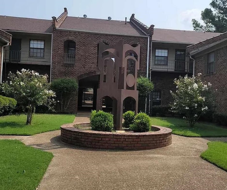 View of front of house with brick siding and a front lawn