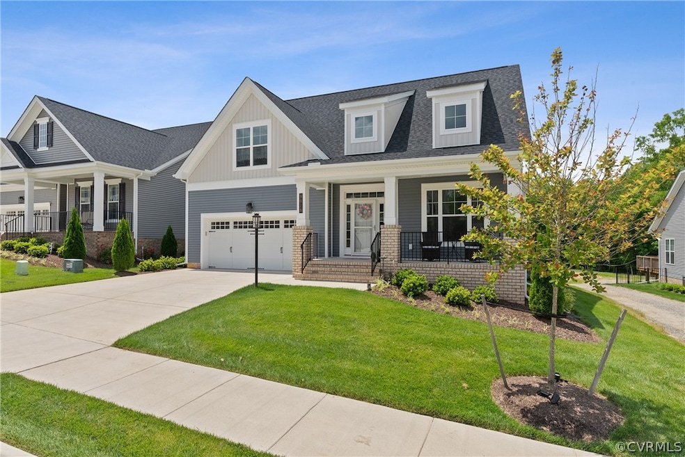 View of front of house with a garage, a front lawn