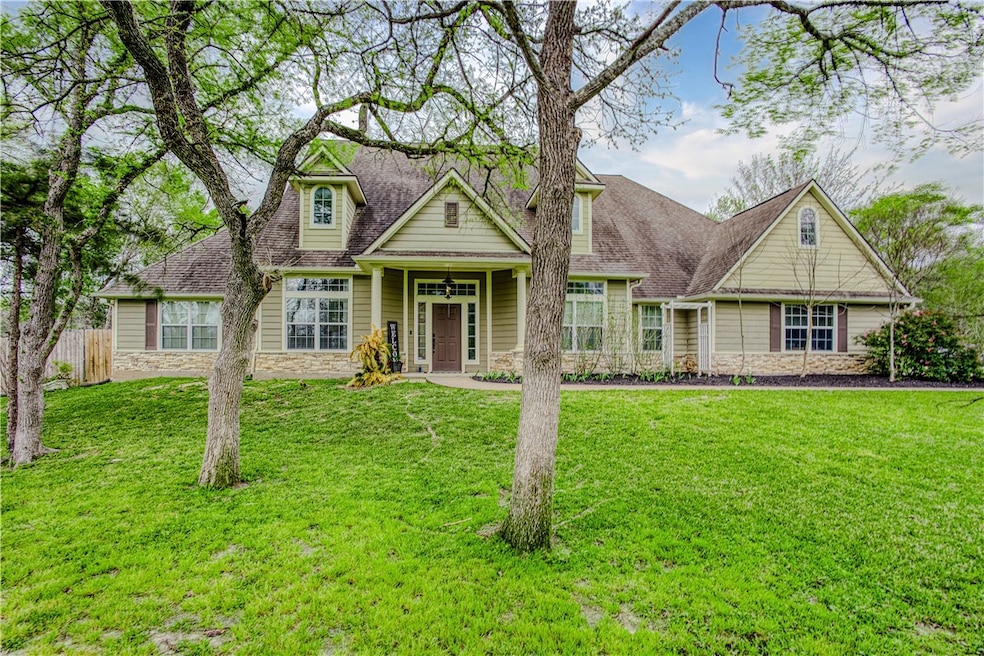 View of front of property featuring stone siding,