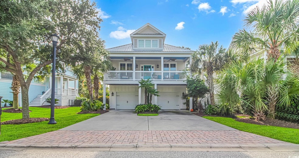 Coastal home with a front lawn, covered porch, and