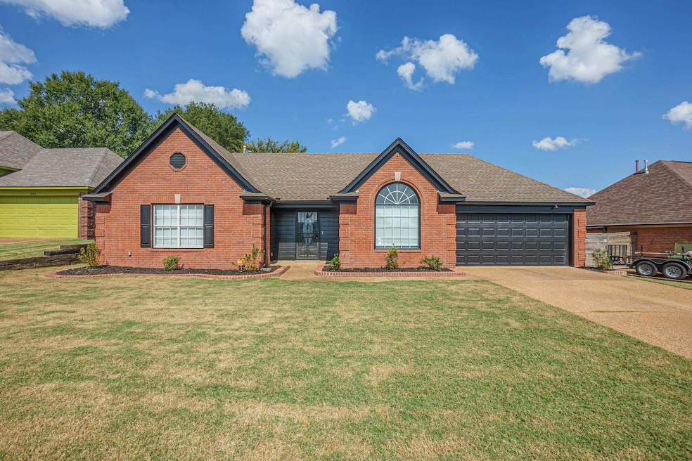 Ranch-style home featuring a garage and a front la