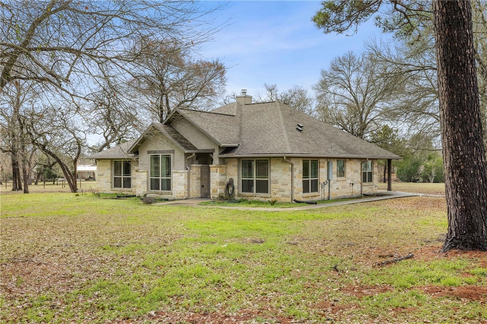 View of front of home with stone siding, roof with