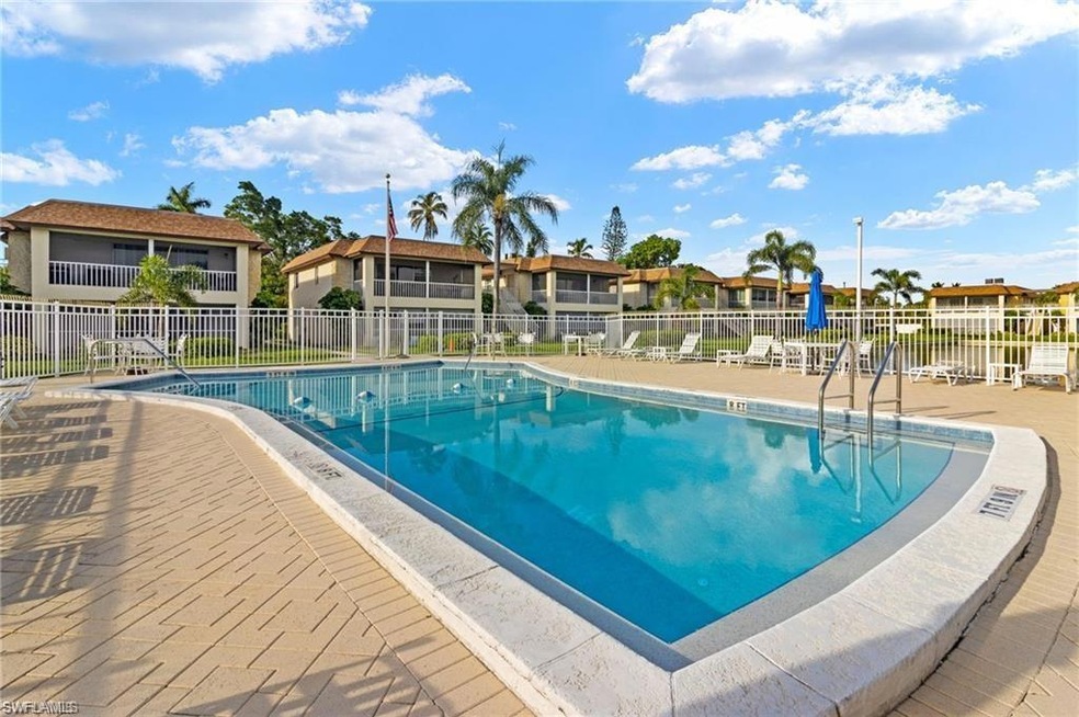 Community pool featuring a residential view and fence