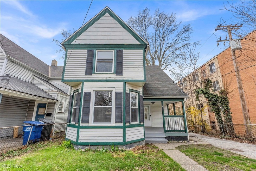 View of front of property featuring fence and a porch