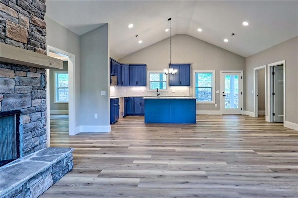 Kitchen with a stone fireplace, high vaulted ceili