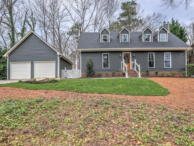 Charming Cape Code style home sits on a knoll over