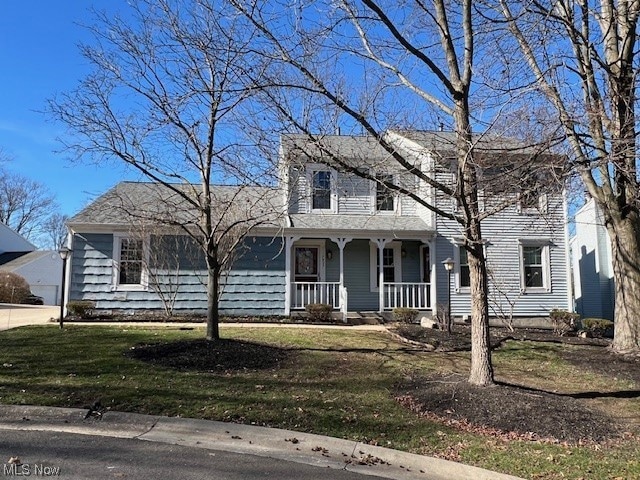 View of front of home featuring a front lawn and a porch