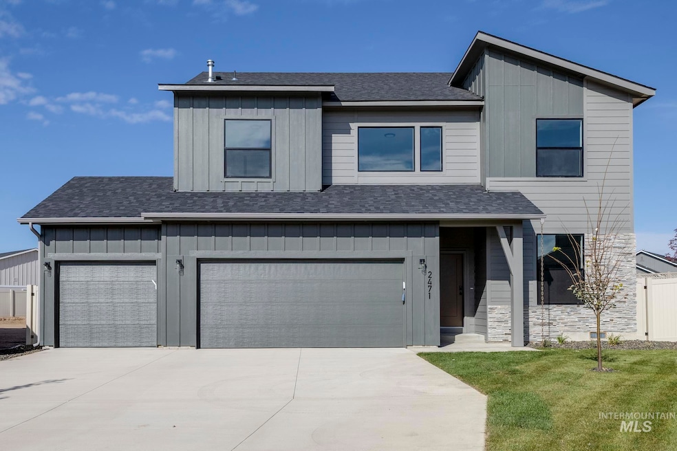 View of front of property featuring board and batten siding, a shingled roof, and concrete driveway