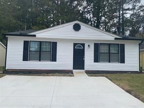 View of front of house featuring concrete driveway