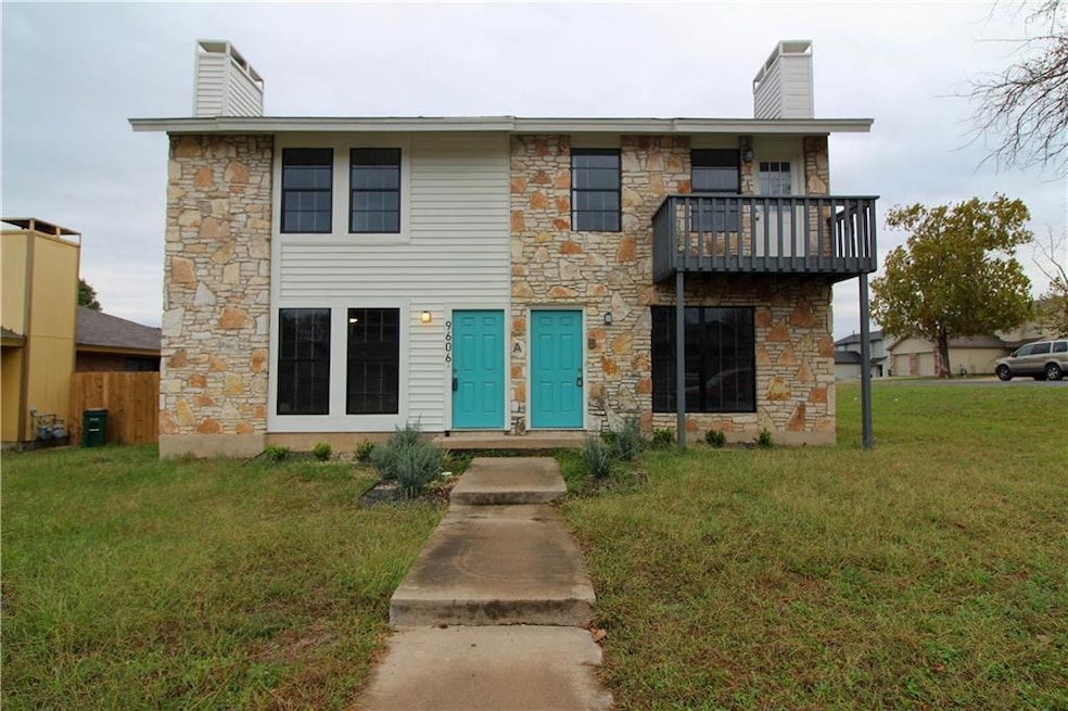 View of front of home with a front yard, a balcon