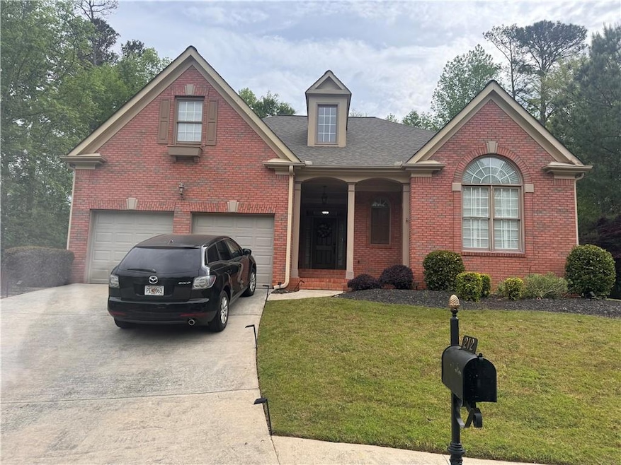 Front of property with a garage and a front yard